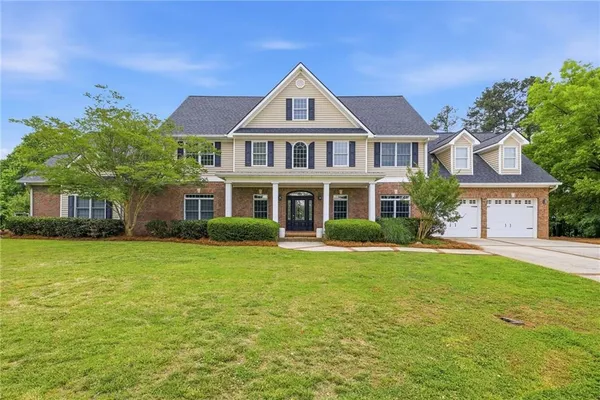 a front view of a house with a yard