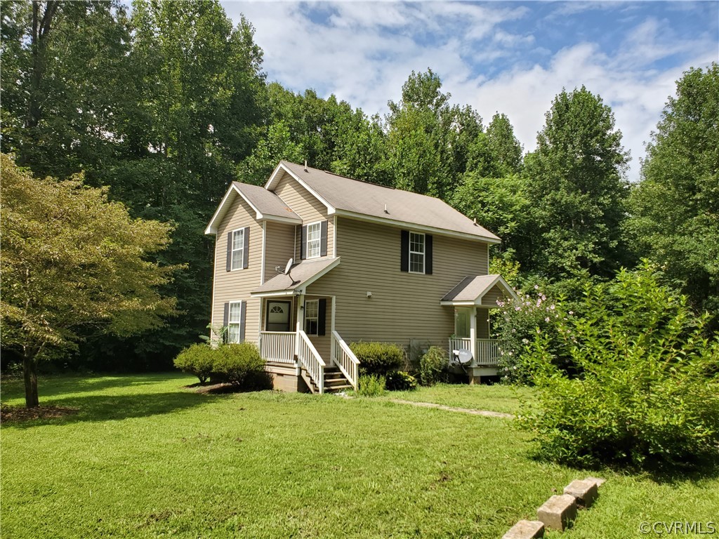 4094 Cedar Plains Road Sandy Hook, VA 23153 - Photo 1 of 9 a view of a house with big yard and large trees