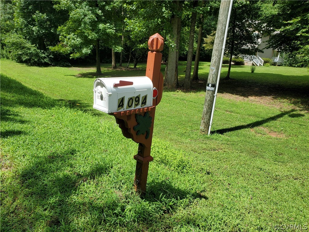 4094 Cedar Plains Road Sandy Hook, VA 23153 - Photo 2 of 9 a garden view with a sitting space
