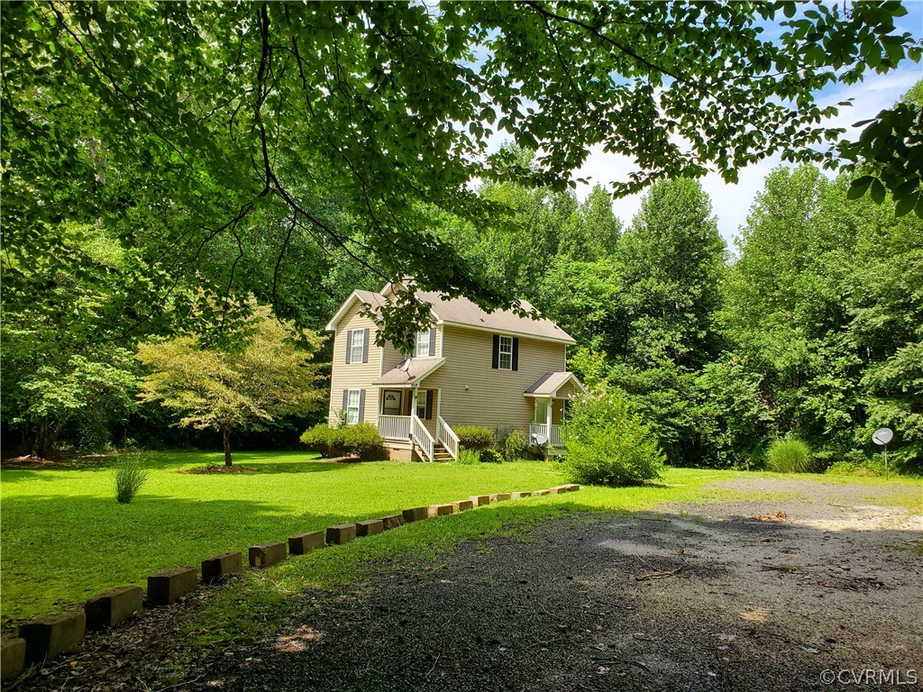 4094 Cedar Plains Road Sandy Hook, VA 23153 - Photo 3 of 9 a front view of a house with yard