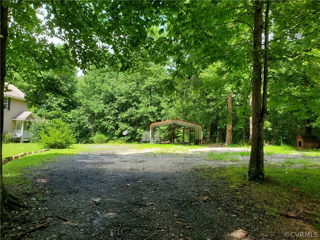 4094 Cedar Plains Road Sandy Hook, VA 23153 - Photo 5 of 9 a view of a yard with a tree