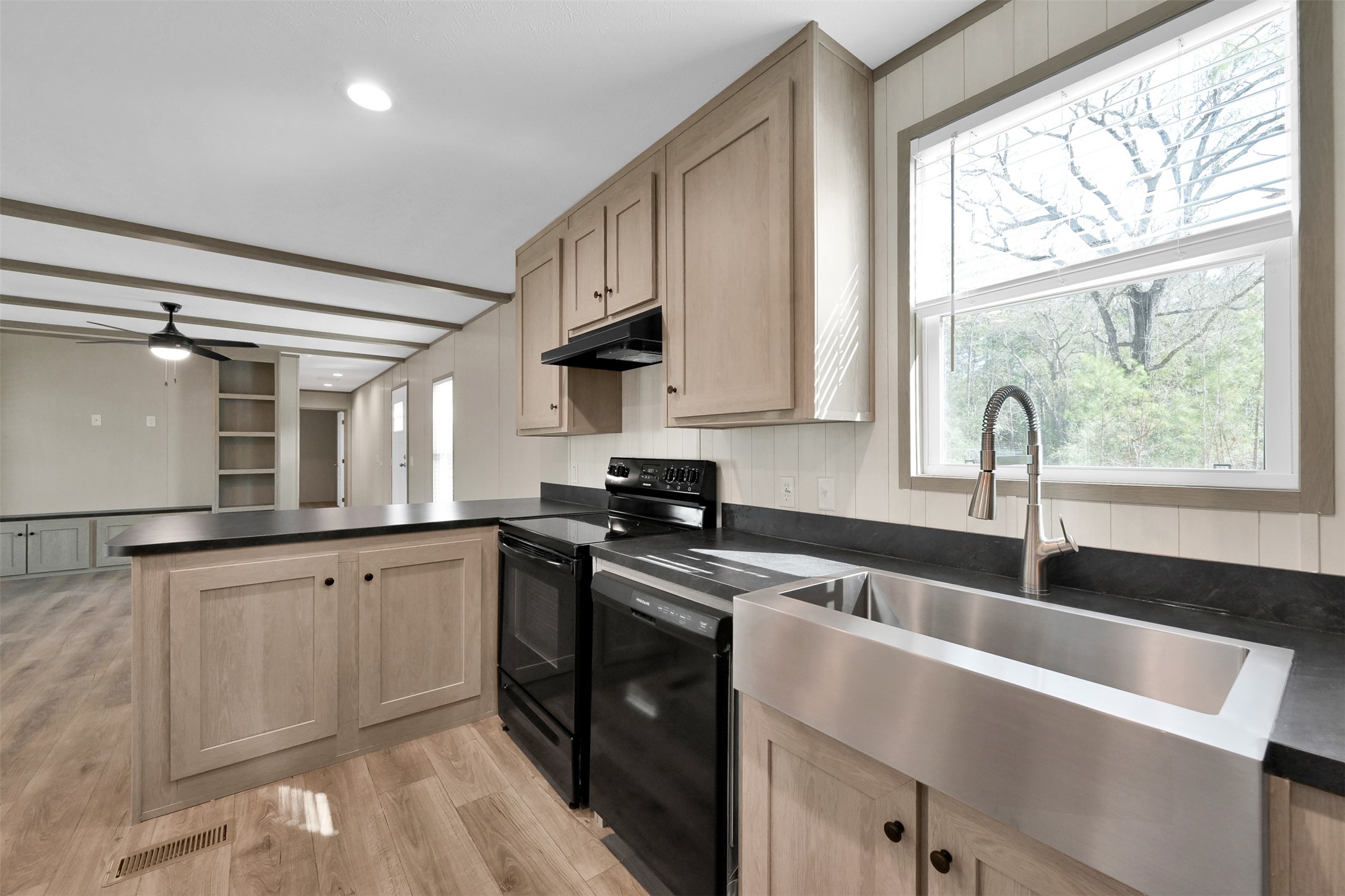 21195 Security Cemetery Road Cleveland, TX 77328 - Photo 11 of 14 a kitchen with granite countertop a sink stainless steel appliances and cabinets