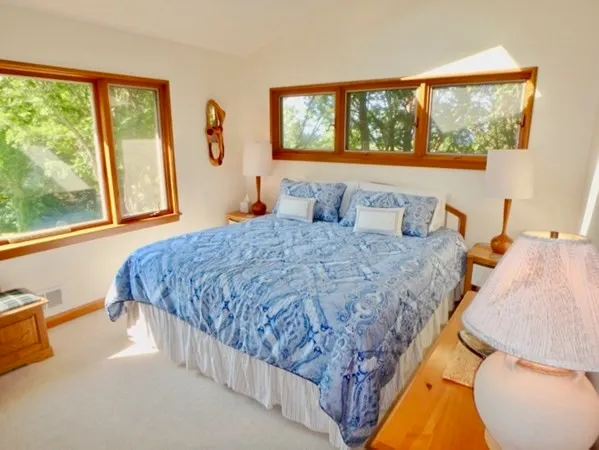 a bedroom with a large bed and a large window