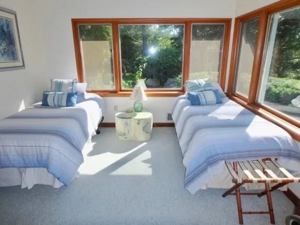 a bedroom with furniture and a large window