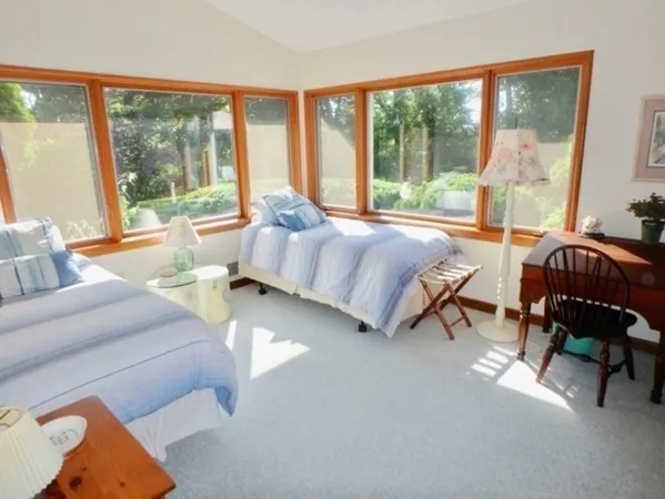 a bedroom with furniture and a large window