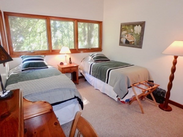 29 Naushon Road West Tisbury, MA 02568 - Photo 15 of 26 a bedroom with two beds and a large window
