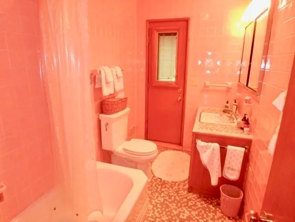 a bathroom with a toilet sink and tub