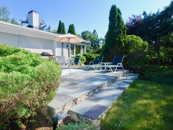 29 Naushon Road West Tisbury, MA 02568 - Photo 23 of 26 a view of a patio with table and chairs potted plants and large tree