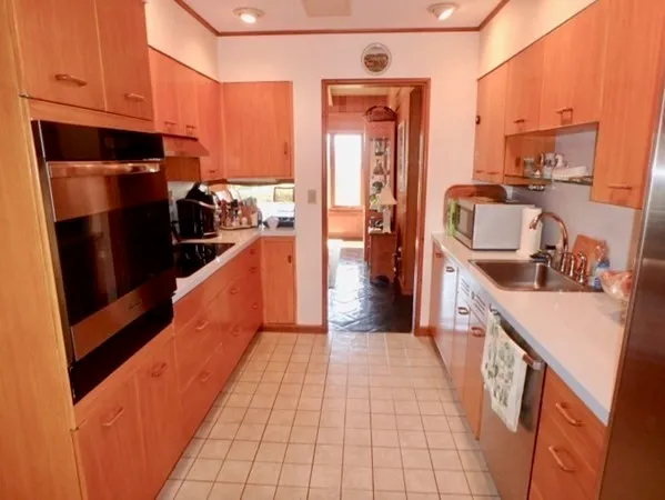 a kitchen with stainless steel appliances a sink stove and refrigerator