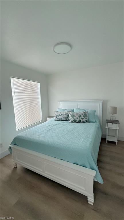 2235 San Marco Road, Unit 5204 Marco Island, FL 34145 - Photo 31 of 34 Spacious room featuring wood-finish flooring, a window with horizontal blinds, and a flush-mount ceiling light