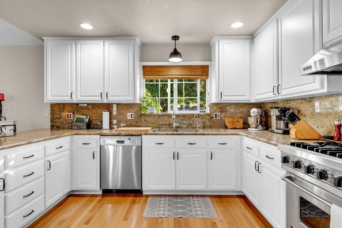 12269 Dry Creek Road Bella Vista, CA 96008 - Photo 16 of 74 a kitchen with granite countertop white cabinets and white appliances