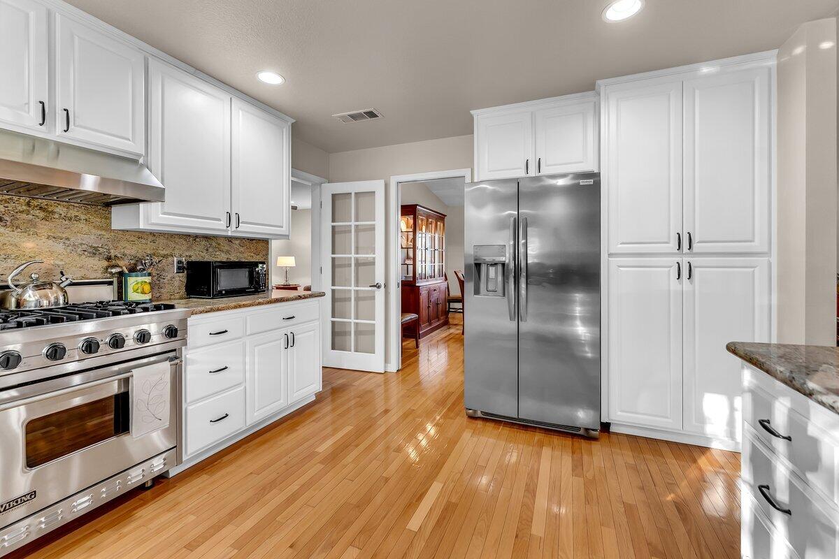 12269 Dry Creek Road Bella Vista, CA 96008 - Photo 17 of 74 a kitchen with stainless steel appliances granite countertop a refrigerator and a stove top oven
