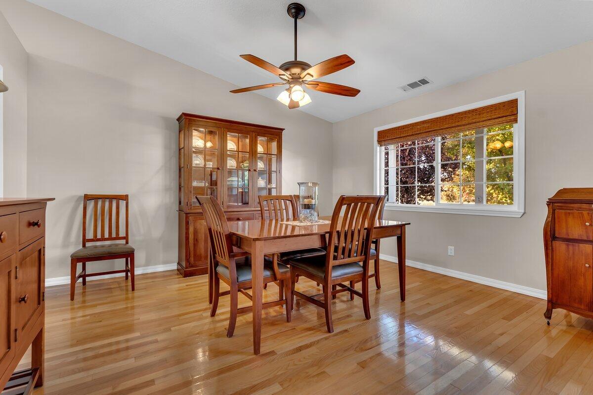12269 Dry Creek Road Bella Vista, CA 96008 - Photo 18 of 74 a dining room with furniture a chandelier and wooden floor