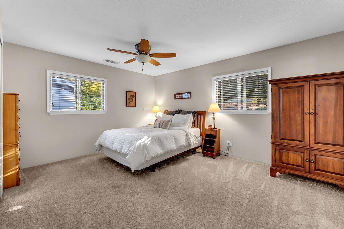 12269 Dry Creek Road Bella Vista, CA 96008 - Photo 20 of 74 a bedroom with a bed dresser and a window