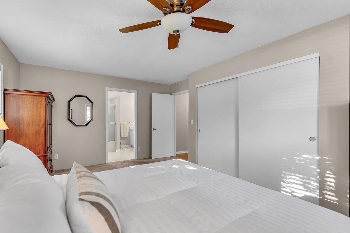 12269 Dry Creek Road Bella Vista, CA 96008 - Photo 22 of 74 a bedroom with a bed and a chandelier