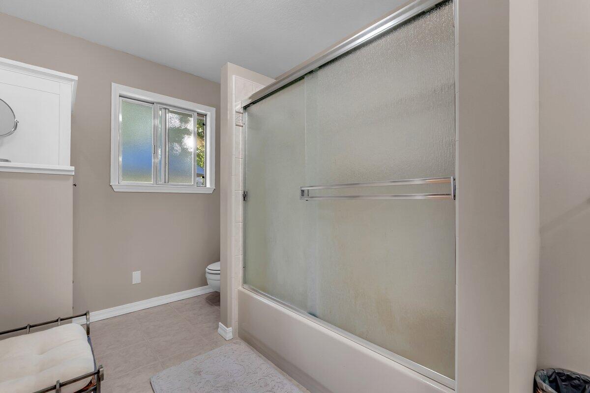 12269 Dry Creek Road Bella Vista, CA 96008 - Photo 27 of 74 a bathroom with a bathtub and a shower