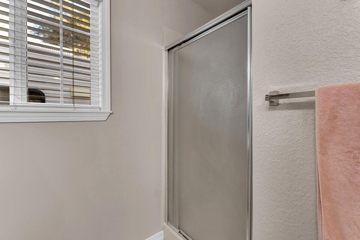12269 Dry Creek Road Bella Vista, CA 96008 - Photo 29 of 74 a bathroom with a shower and a window