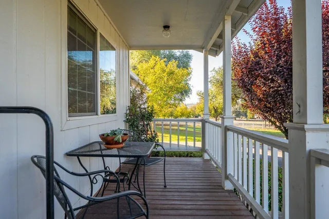 a view of a porch with wooden floor and outdoor space