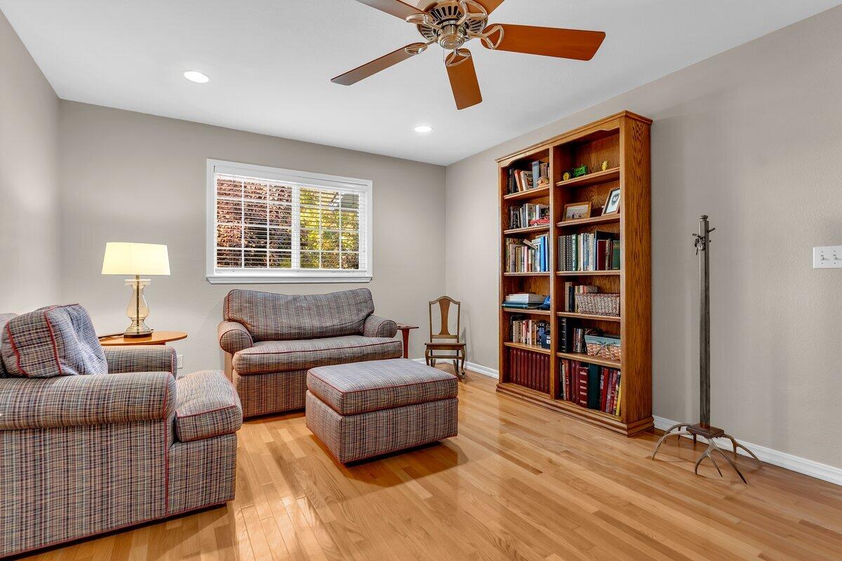 12269 Dry Creek Road Bella Vista, CA 96008 - Photo 32 of 74 a living room with furniture and a book shelf