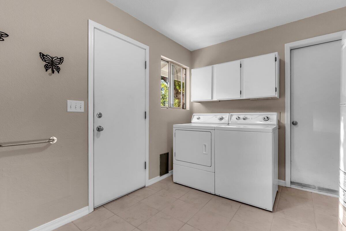 12269 Dry Creek Road Bella Vista, CA 96008 - Photo 33 of 74 a utility room with cabinets washer and dryer