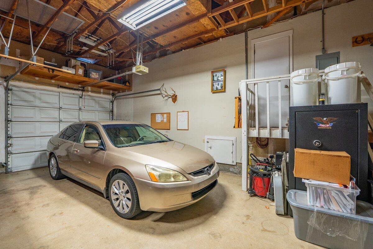 12269 Dry Creek Road Bella Vista, CA 96008 - Photo 35 of 74 a car and bike parked in a garage