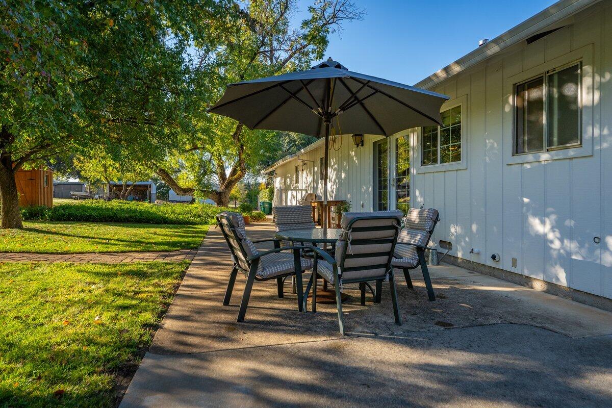 12269 Dry Creek Road Bella Vista, CA 96008 - Photo 39 of 74 a view of a swimming pool with a table and chairs under an umbrella