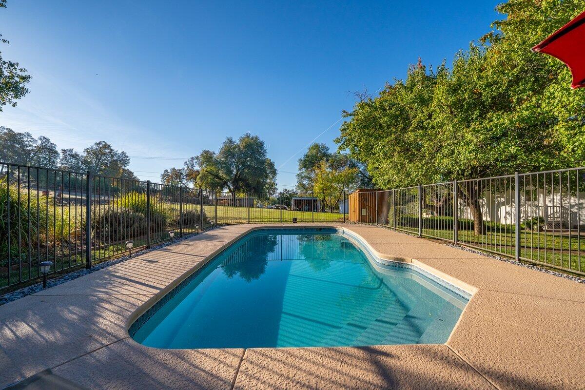 12269 Dry Creek Road Bella Vista, CA 96008 - Photo 43 of 74 a view of a swimming pool with a patio