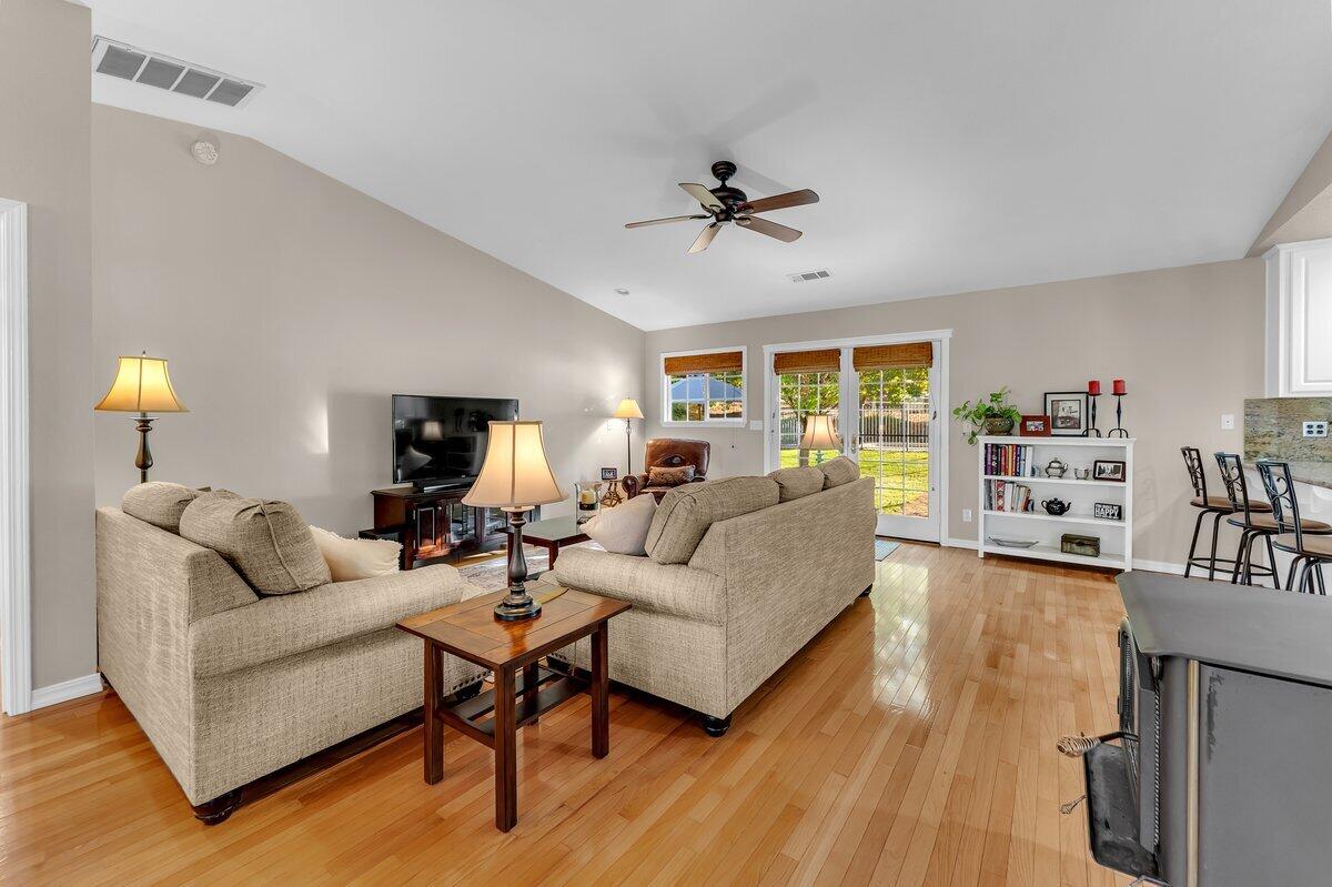 12269 Dry Creek Road Bella Vista, CA 96008 - Photo 9 of 74 a living room with furniture and a wooden floor
