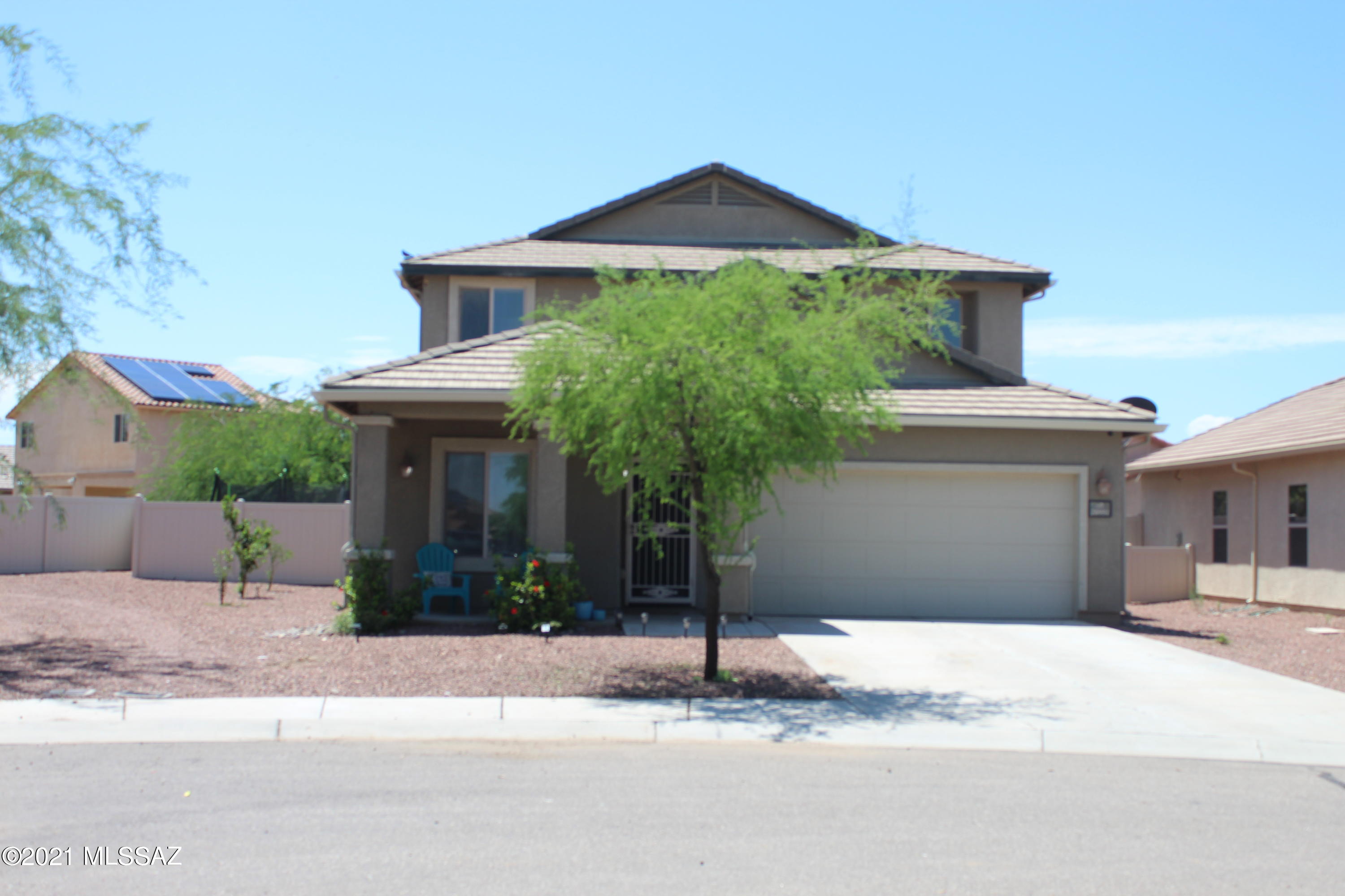 20951 East Reunion Road Red Rock, AZ 85145 - Photo 2 of 35 a front view of a house with a yard and garage