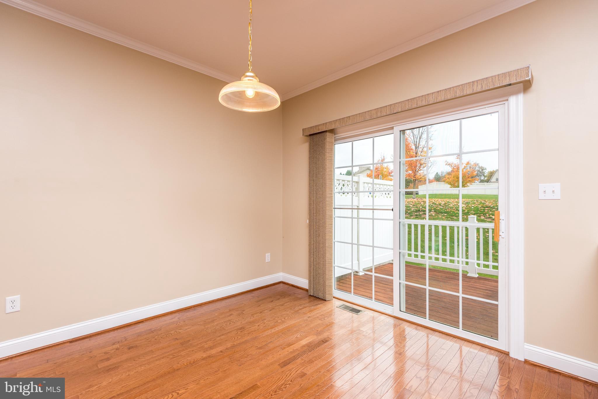 3233 Meadow View Circle, Unit 155 Furlong, PA 18925 - Photo 14 of 36 an empty room with wooden floor and windows