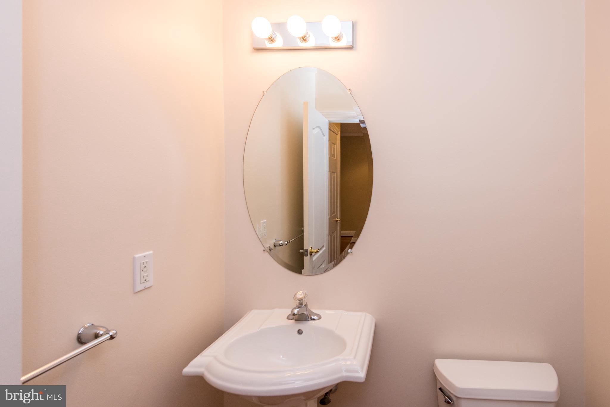 3233 Meadow View Circle, Unit 155 Furlong, PA 18925 - Photo 17 of 36 a bathroom with a sink and a mirror