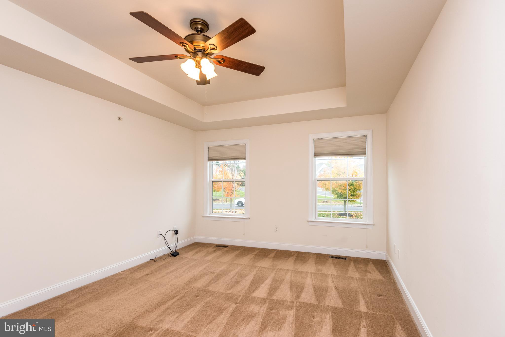 3233 Meadow View Circle, Unit 155 Furlong, PA 18925 - Photo 20 of 36 an empty room with windows and fan