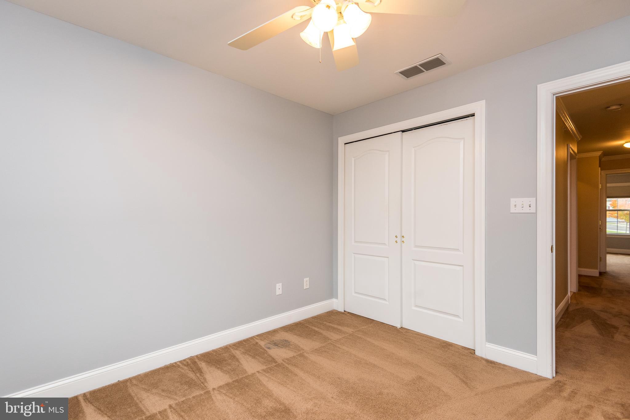 3233 Meadow View Circle, Unit 155 Furlong, PA 18925 - Photo 26 of 36 an empty room with a chandelier fan