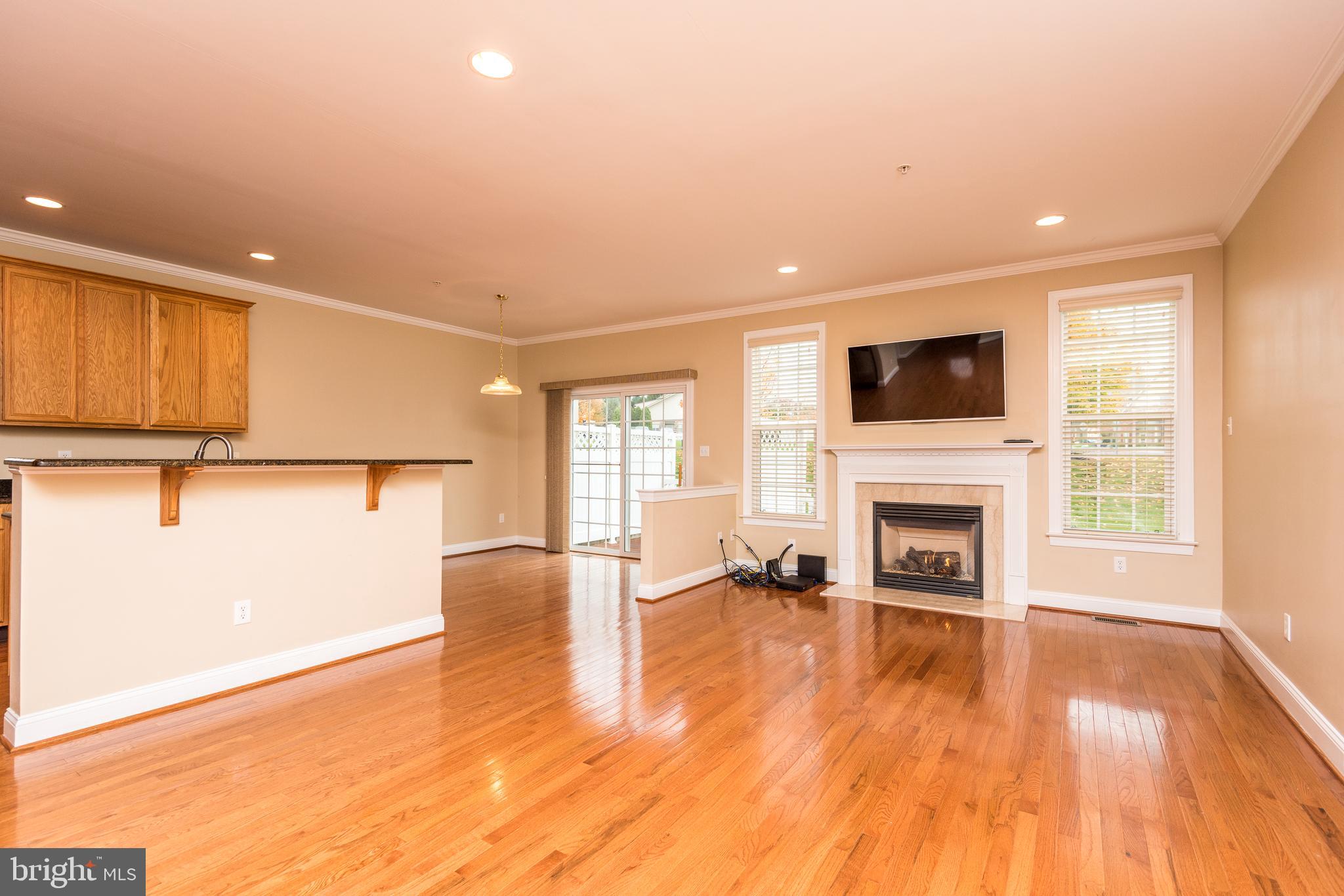 3233 Meadow View Circle, Unit 155 Furlong, PA 18925 - Photo 8 of 36 a view of empty room with fireplace and wooden floor