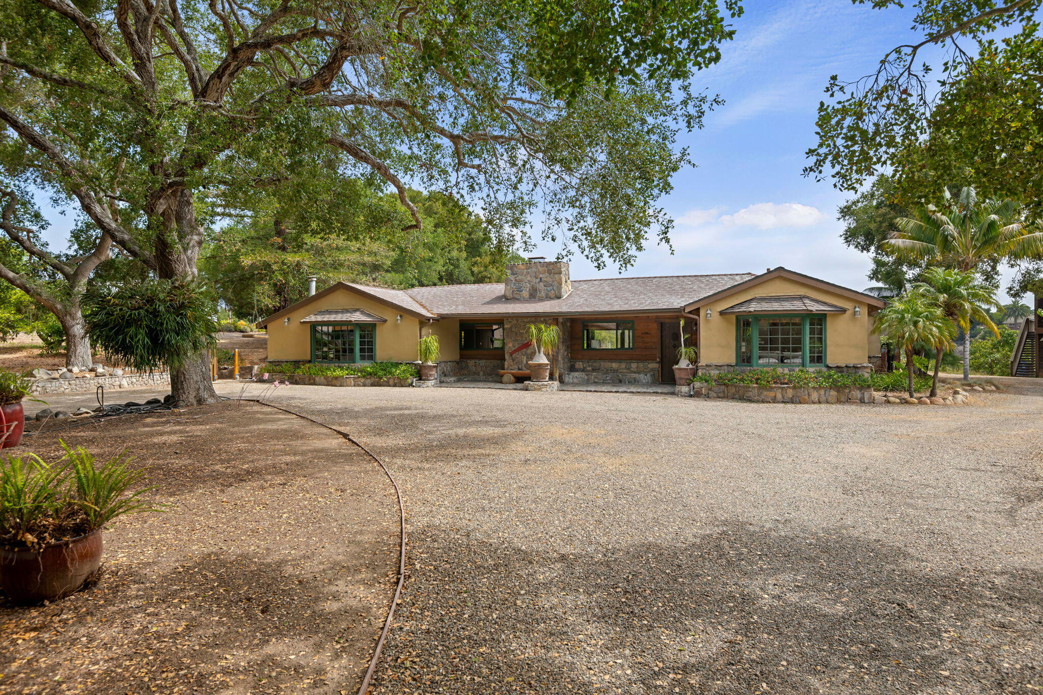 3520 La Entrada Santa Barbara, CA 93105 - Photo 2 of 12 a front view of a house with a yard and potted plants