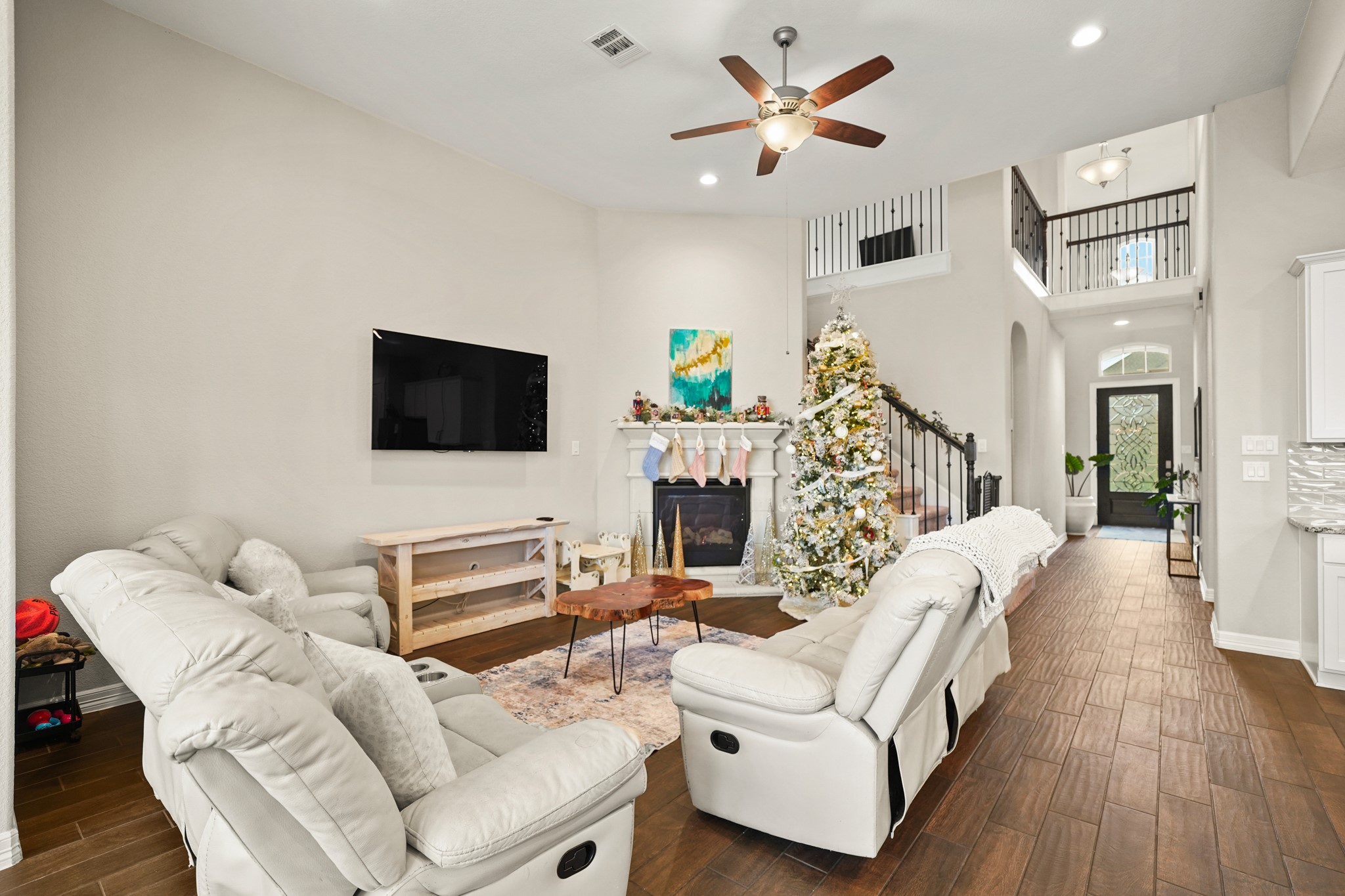 24031 Corinaldo Court Katy, TX 77493 - Photo 8 of 23 a living room with furniture a flat screen tv and a fireplace