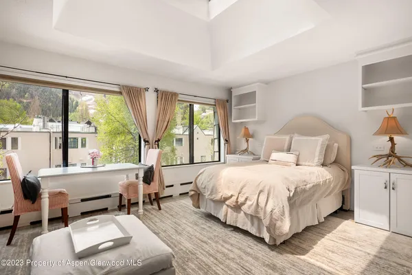 a bedroom with a large bed and a large window