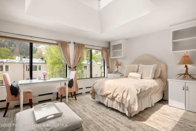 a bedroom with a large bed and a large window