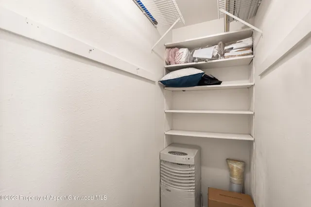 a view of walk in closet with empty racks