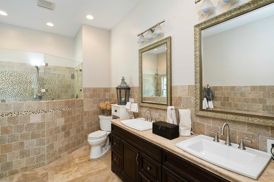 89 Old Hyannis Road Yarmouth Port, MA 02675 - Photo 17 of 35 a bathroom with a double vanity sink toilet and a mirror