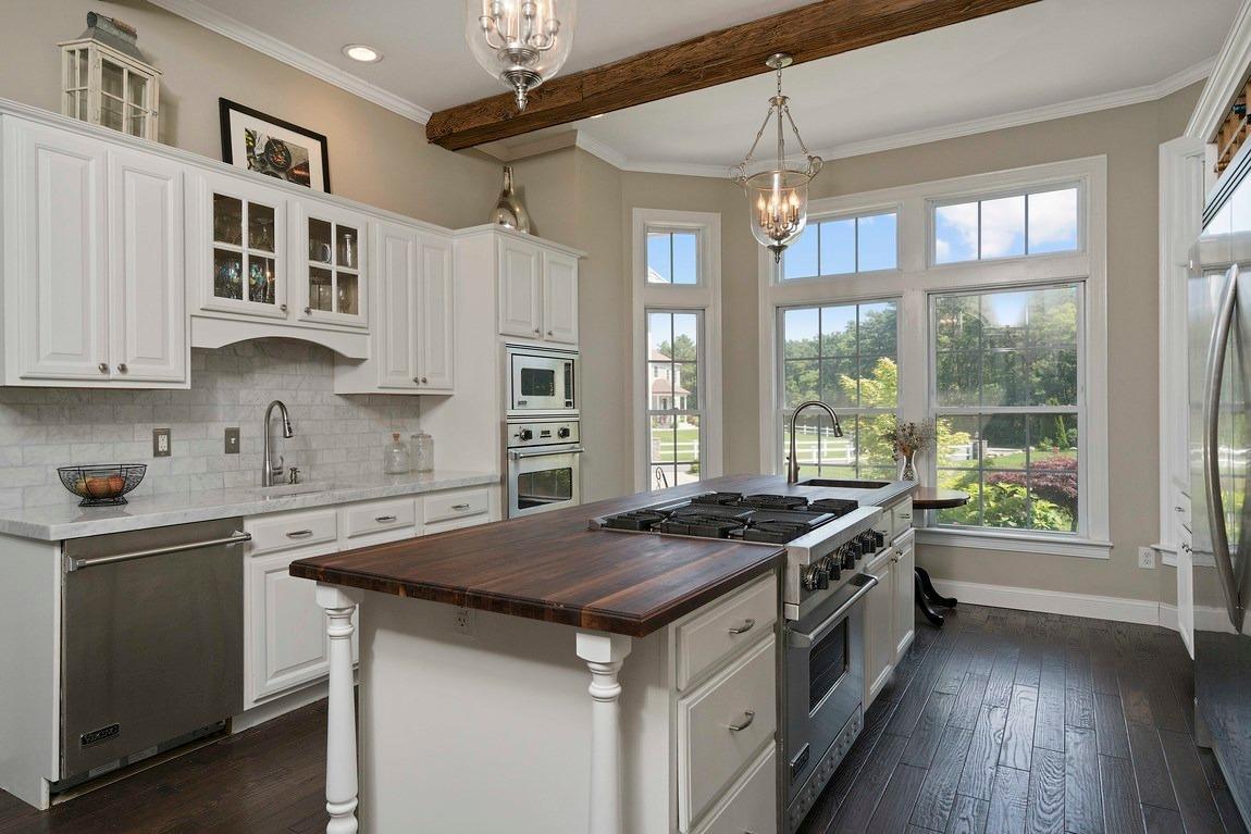 89 Old Hyannis Road Yarmouth Port, MA 02675 - Photo 8 of 35 a kitchen that has a sink a stove and a wooden floor