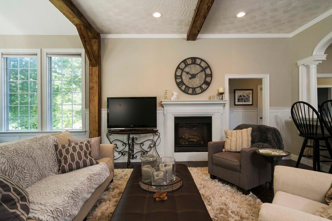 89 Old Hyannis Road Yarmouth Port, MA 02675 - Photo 10 of 35 a living room with furniture a fireplace and a large window