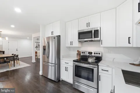 a kitchen with stainless steel appliances a stove microwave and a refrigerator