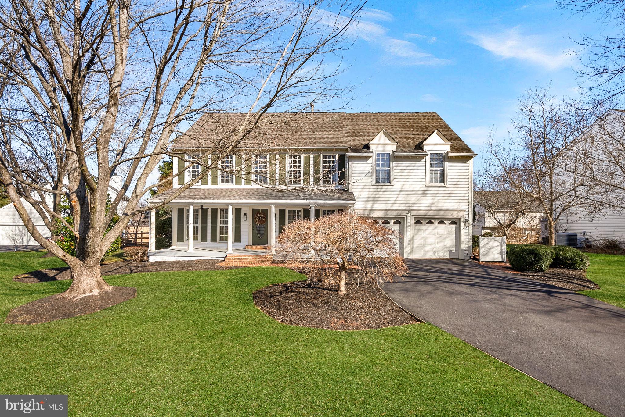 9440 Flowerden Lane Manassas, VA 20110 - Photo 2 of 66 a front view of a house with a garden
