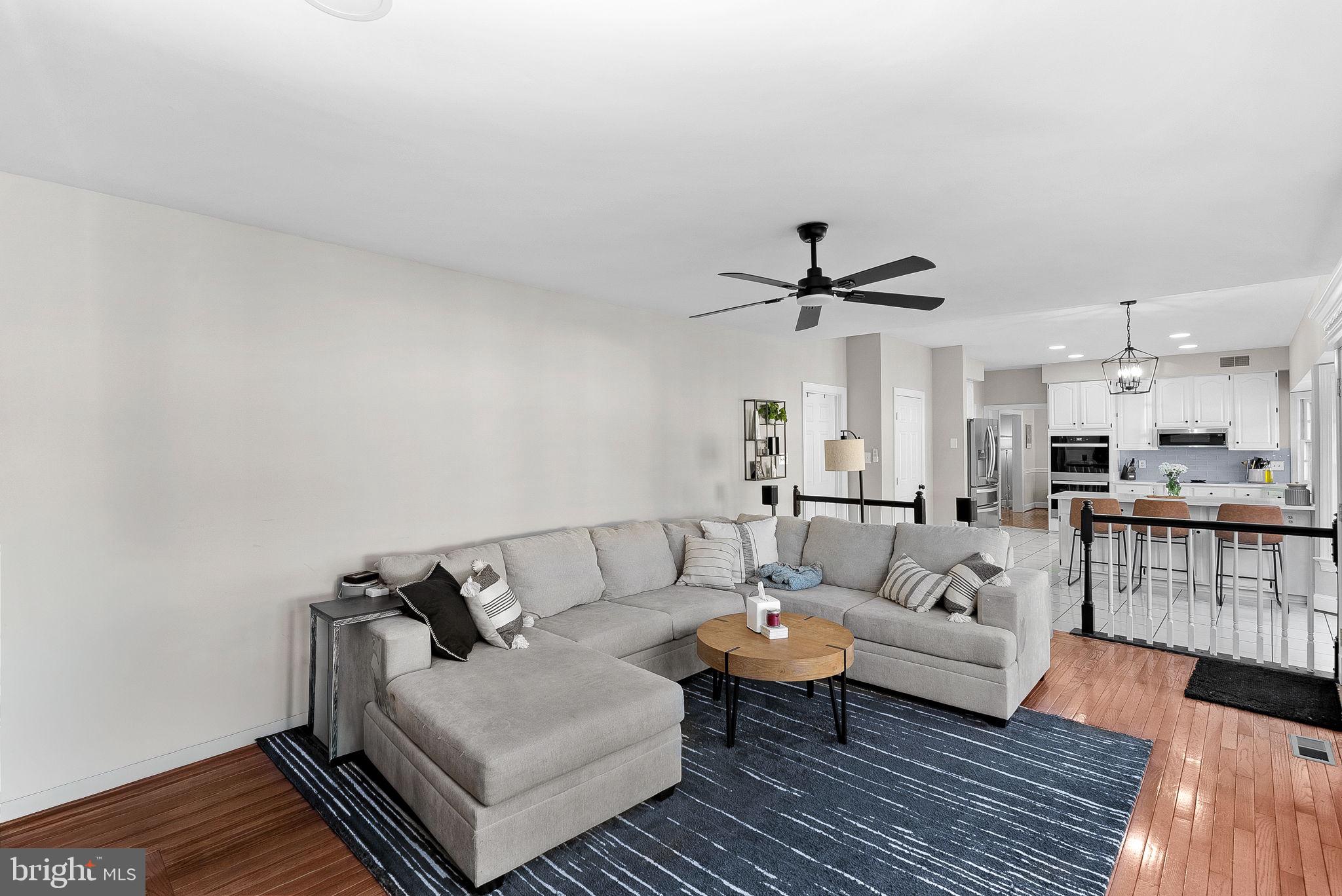 9440 Flowerden Lane Manassas, VA 20110 - Photo 22 of 66 a living room with furniture and a wooden floor
