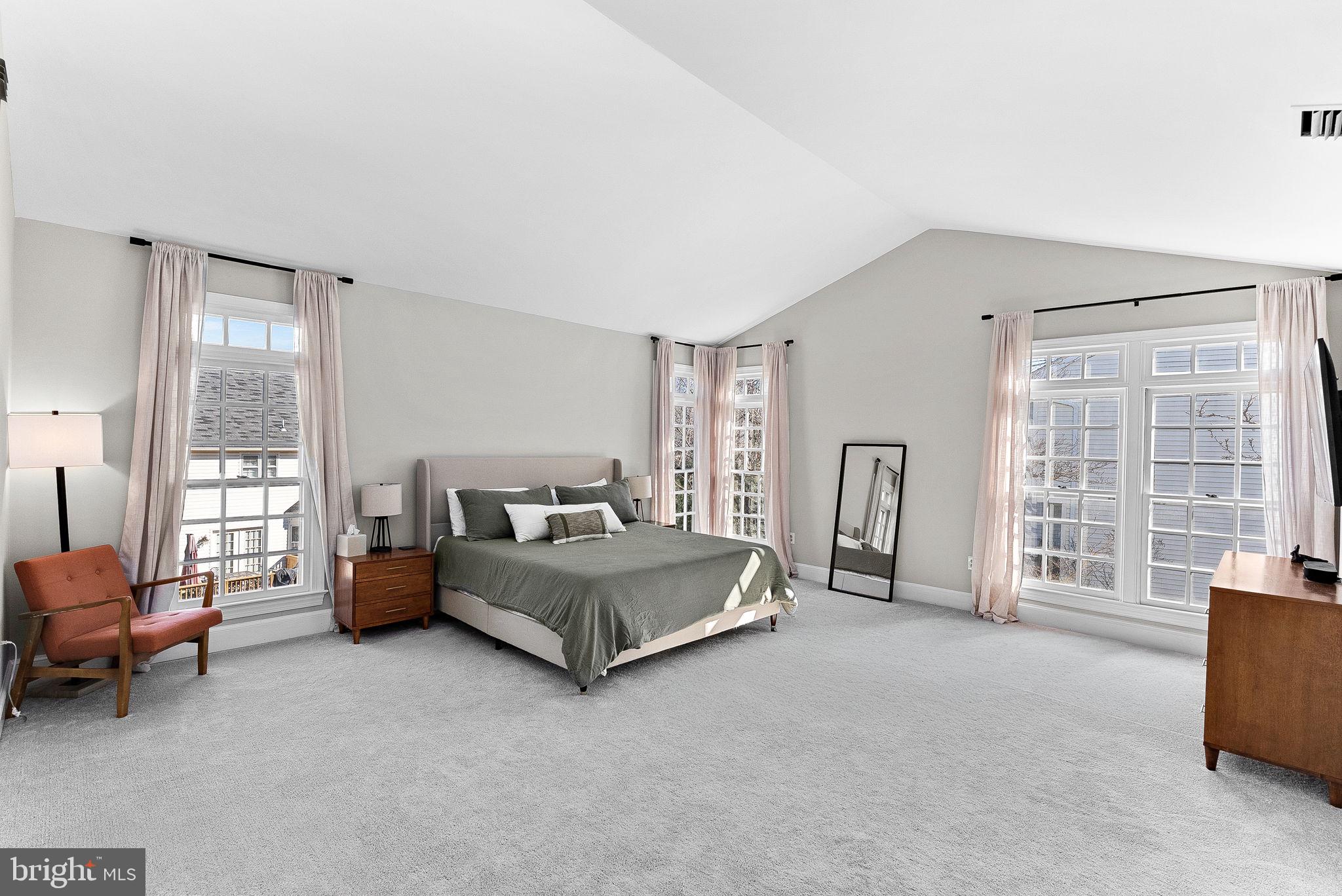 9440 Flowerden Lane Manassas, VA 20110 - Photo 27 of 66 a spacious bedroom with a bed and a couch