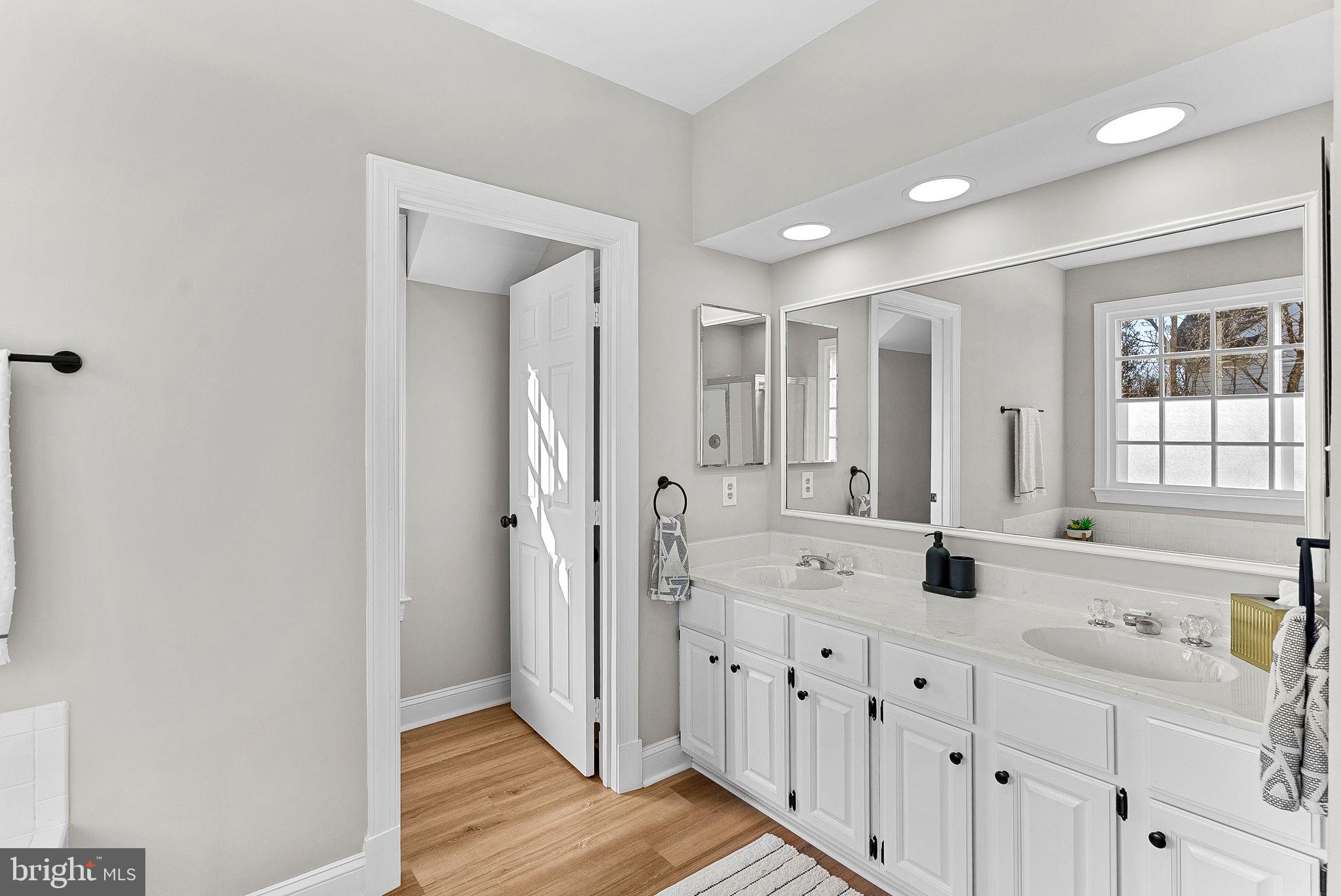 9440 Flowerden Lane Manassas, VA 20110 - Photo 33 of 66 a bathroom with a double vanity sink a mirror and a shower