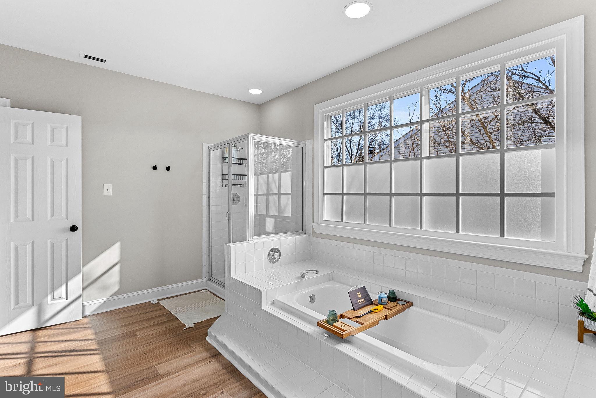 9440 Flowerden Lane Manassas, VA 20110 - Photo 35 of 66 a bathroom with a tub and a large window