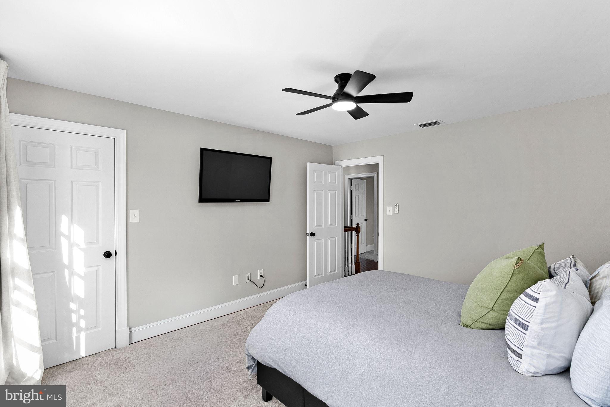 9440 Flowerden Lane Manassas, VA 20110 - Photo 38 of 66 a bedroom with a bed and a television