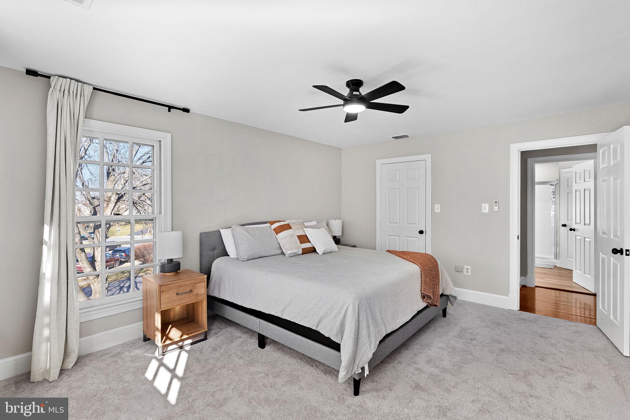 9440 Flowerden Lane Manassas, VA 20110 - Photo 41 of 66 a bedroom with a bed and a chandelier